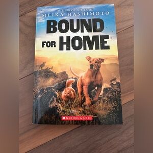 Scholastic 'Bound for Home' with Vibrant Orange and Black Cover